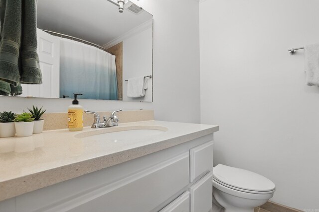 4911 B St, Little Rock, AR 72205 - bathroom featuring vanity, crown molding, toilet, and a shower with shower curtain