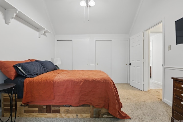 4911 B St, Little Rock, AR 72205 - bedroom with vaulted ceiling, two closets, light colored carpet, and baseboards