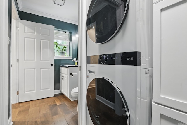 4911 B St, Little Rock, AR 72205 - laundry room with stacked washer and clothes dryer, ornamental molding, and wood finished floors