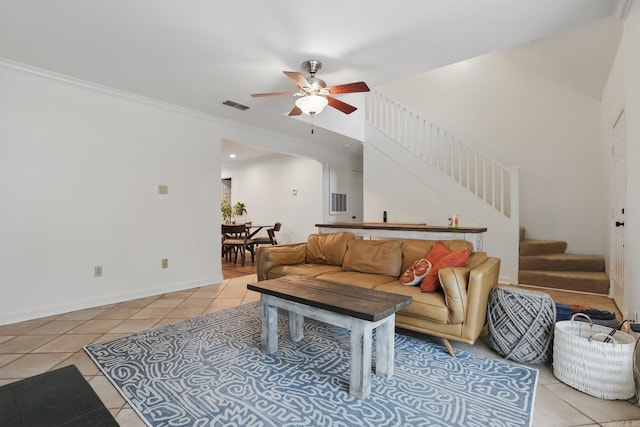 4911 B St, Little Rock, AR 72205 - living area with light tile patterned floors, a ceiling fan, stairs, crown molding, and baseboards
