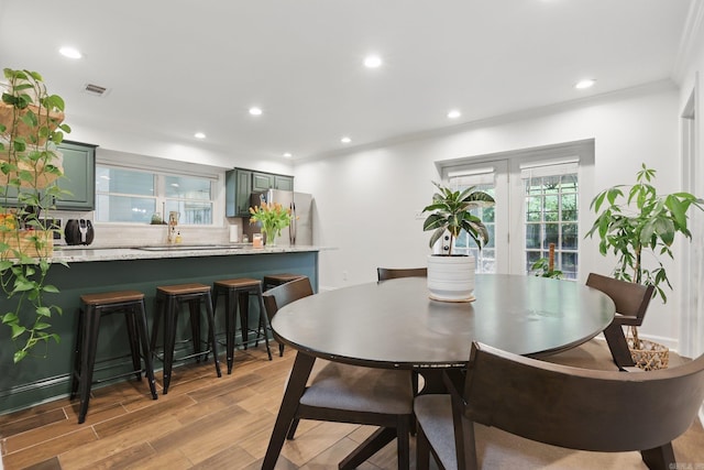 4911 B St, Little Rock, AR 72205 - dining space featuring ornamental molding, recessed lighting, and light wood-style flooring