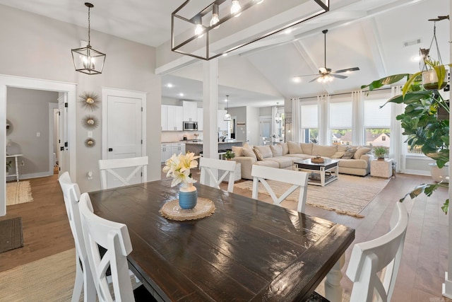5101 Peace Ln, Alexander, AR 72002 - dining area with high vaulted ceiling, light wood finished floors, a ceiling fan, beamed ceiling, and baseboards