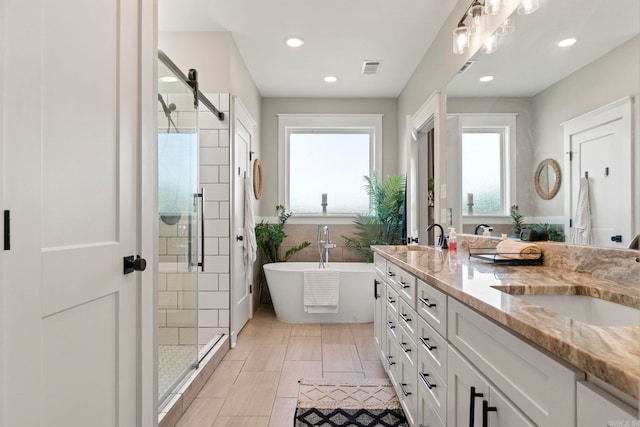 5101 Peace Ln, Alexander, AR 72002 - bathroom featuring a stall shower, a freestanding bath, recessed lighting, and double vanity