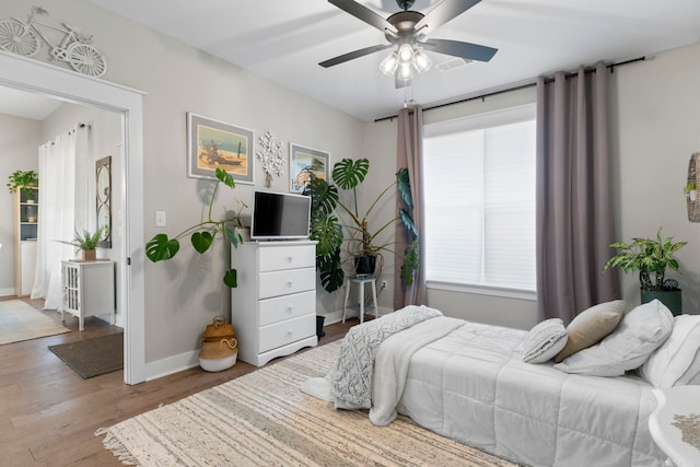 5101 Peace Ln, Alexander, AR 72002 - bedroom featuring wood finished floors, baseboards, and ceiling fan