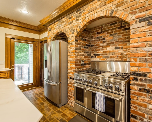 5401 N Hills Blvd, North Little Rock, AR 72116 - kitchen featuring stainless steel appliances, brick flooring, crown molding, light countertops, and brick wall