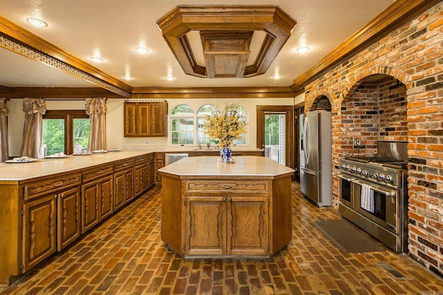 5401 N Hills Blvd, North Little Rock, AR 72116 - kitchen with stainless steel appliances, a kitchen island, light countertops, crown molding, and a sink