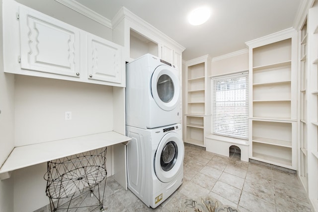 5401 N Hills Blvd, North Little Rock, AR 72116 - laundry area featuring estacked washer and dryer, ornamental molding, and cabinet space