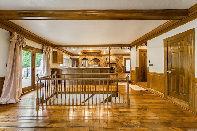 5401 N Hills Blvd, North Little Rock, AR 72116 - interior space with dark wood-style floors, wainscoting, beam ceiling, an upstairs landing, and ornamental molding