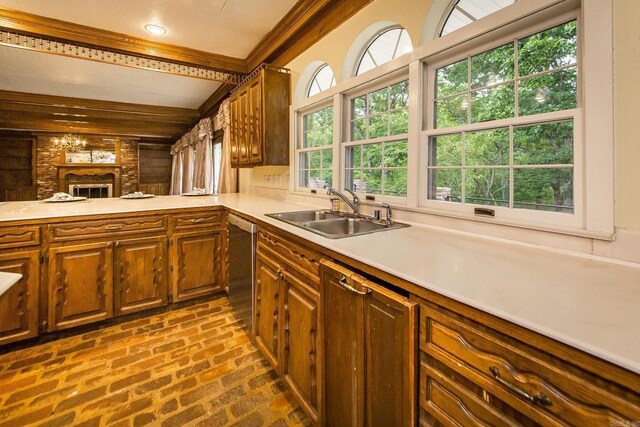 5401 N Hills Blvd, North Little Rock, AR 72116 - kitchen featuring a sink, stainless steel dishwasher, light countertops, brick floors, and brown cabinets