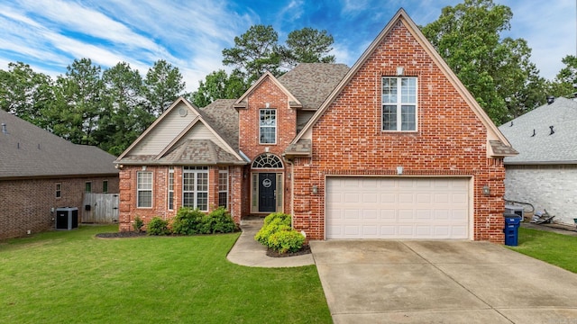 121 Lily Dr, Maumelle, AR 72113 - view of front of home featuring brick siding, cooling unit, concrete driveway, a front lawn, and an attached garage