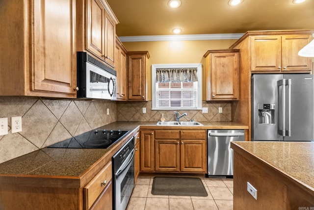 121 Lily Dr, Maumelle, AR 72113 - kitchen featuring appliances with stainless steel finishes, a sink, tile countertops, ornamental molding, and light tile patterned floors