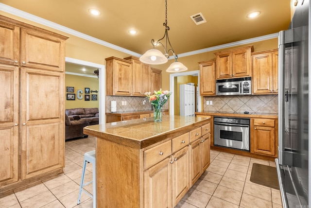 121 Lily Dr, Maumelle, AR 72113 - kitchen featuring stainless steel appliances, a center island, crown molding, light tile patterned flooring, and backsplash