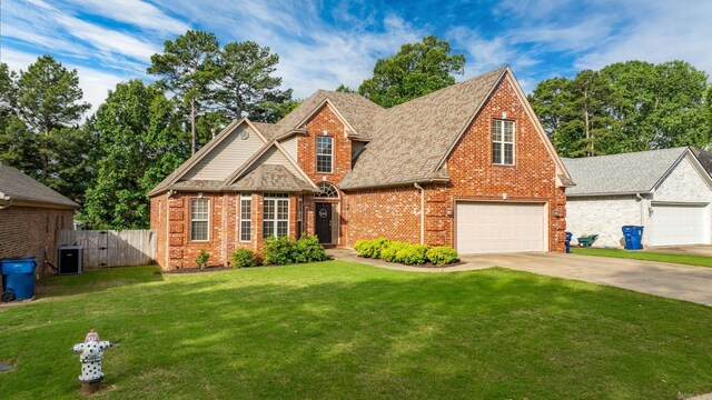 121 Lily Dr, Maumelle, AR 72113 - traditional-style house featuring brick siding, concrete driveway, and roof with shingles