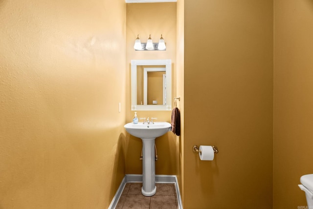 121 Lily Dr, Maumelle, AR 72113 - half bath with tile patterned floors, toilet, and baseboards