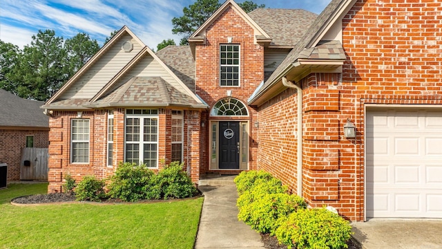 121 Lily Dr, Maumelle, AR 72113 - view of front of home with brick siding, roof with shingles, and a front yard