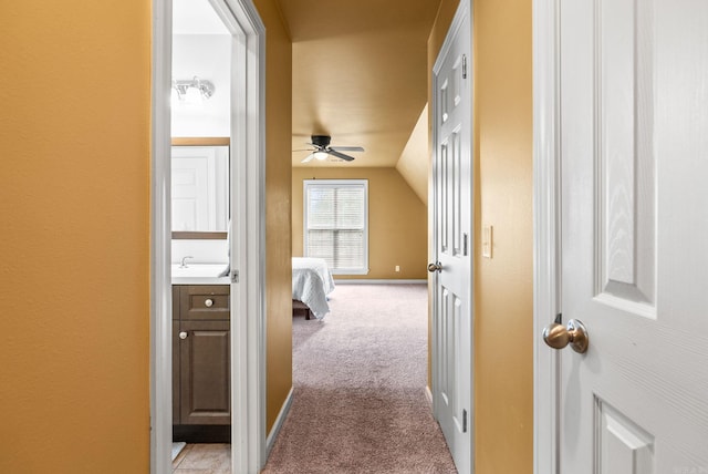 121 Lily Dr, Maumelle, AR 72113 - corridor with light carpet, a sink, and lofted ceiling
