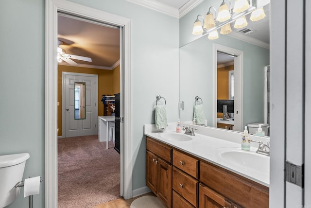121 Lily Dr, Maumelle, AR 72113 - bathroom with ornamental molding, toilet, double vanity, and ceiling fan