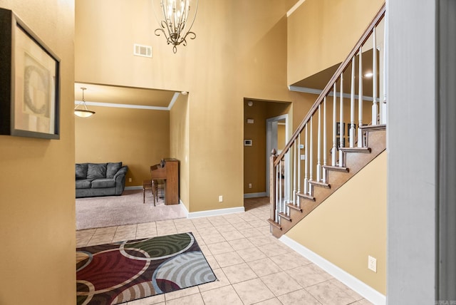 121 Lily Dr, Maumelle, AR 72113 - foyer featuring a towering ceiling, stairway, tile patterned floors, baseboards, and ornamental molding
