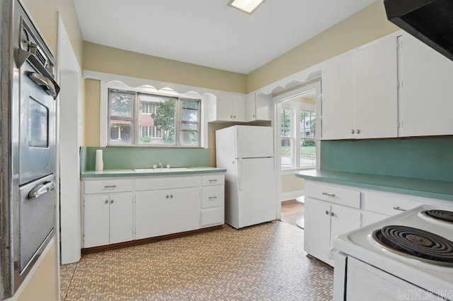 201 E 21st St, Little Rock, AR 72206 - kitchen featuring white appliances, a sink, white cabinetry, and light countertops