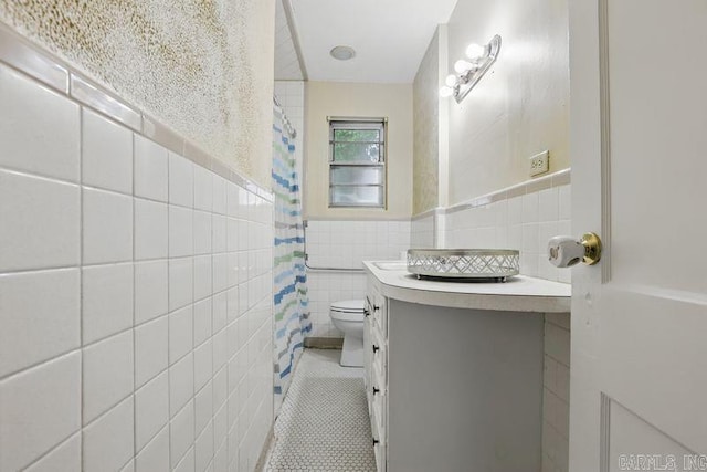 201 E 21st St, Little Rock, AR 72206 - bathroom featuring tile walls, vanity, tile patterned flooring, toilet, and a shower with curtain