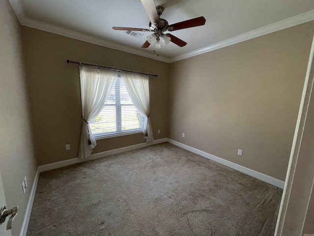 carpeted spare room featuring ornamental molding, a ceiling fan, and baseboards