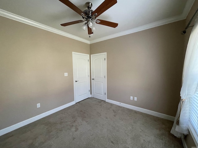 unfurnished bedroom with baseboards, ornamental molding, carpet, and a ceiling fan