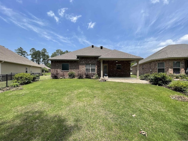 back of house with a patio, brick siding, and a shingled roof