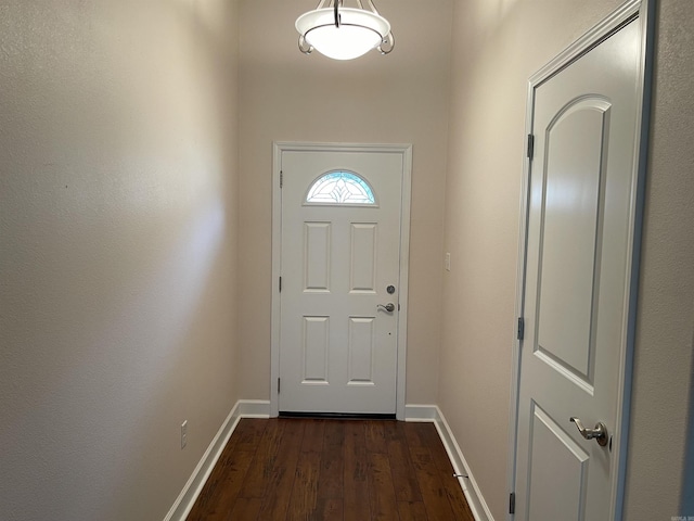 entryway featuring dark wood-style floors and baseboards