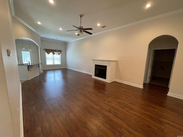 unfurnished living room featuring arched walkways, a fireplace, a ceiling fan, dark wood-style floors, and recessed lighting
