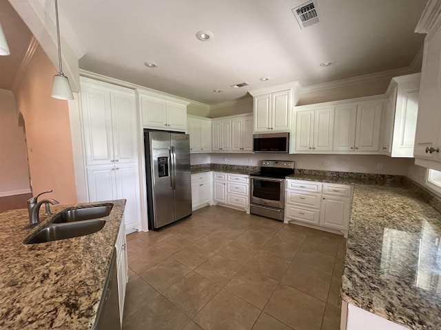 kitchen with appliances with stainless steel finishes, a sink, crown molding, tile patterned floors, and white cabinetry