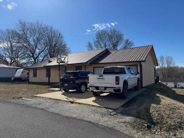 21 Emma Dr, Pocahontas, AR 72455 - view of front of property with metal roof, a garage, and driveway