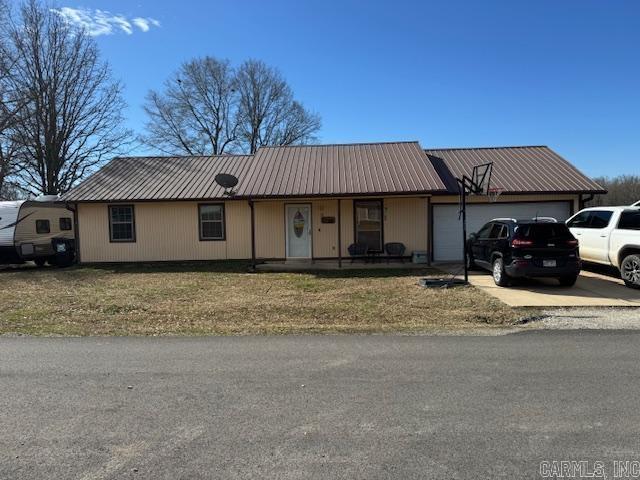 21 Emma Dr, Pocahontas, AR 72455 - ranch-style home with an attached garage, metal roof, a front yard, and driveway
