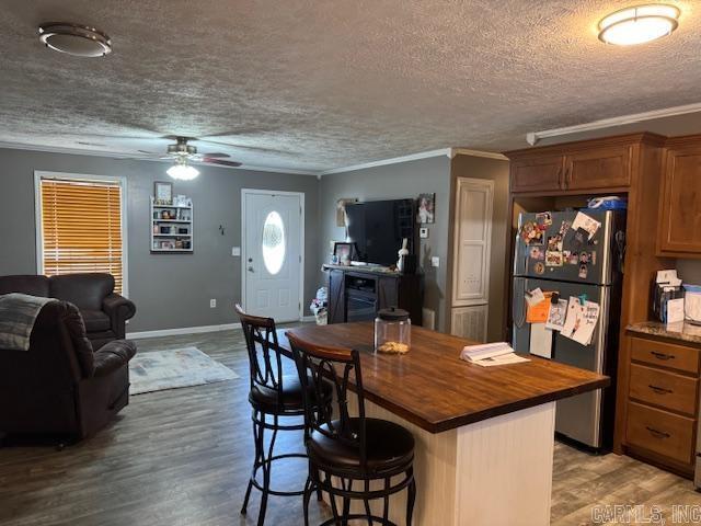 21 Emma Dr, Pocahontas, AR 72455 - kitchen with freestanding refrigerator, butcher block counters, a ceiling fan, a textured ceiling, and ornamental molding
