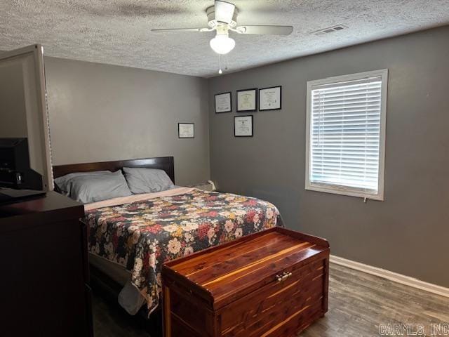 21 Emma Dr, Pocahontas, AR 72455 - bedroom with a textured ceiling, wood finished floors, ceiling fan, and baseboards
