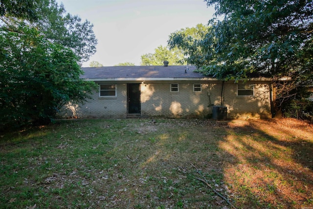 6914 Juniper Rd, Little Rock, AR 72209 - rear view of house with brick siding, central air condition unit, and a yard