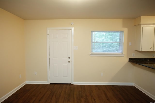 6914 Juniper Rd, Little Rock, AR 72209 - unfurnished dining area with dark wood-style floors and baseboards