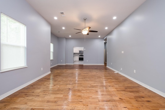 1407 Hanger St, Little Rock, AR 72202 - unfurnished living room with a ceiling fan, light wood-type flooring, recessed lighting, and baseboards