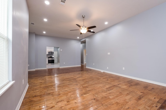 1407 Hanger St, Little Rock, AR 72202 - unfurnished living room featuring ceiling fan, recessed lighting, light wood-style floors, and baseboards