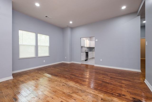 1407 Hanger St, Little Rock, AR 72202 - empty room featuring light wood-style floors, recessed lighting, and baseboards
