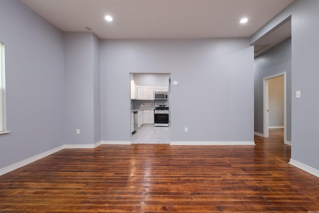 1407 Hanger St, Little Rock, AR 72202 - unfurnished living room featuring light wood-style flooring, recessed lighting, and baseboards