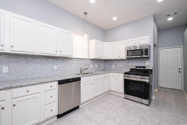 1407 Hanger St, Little Rock, AR 72202 - kitchen with appliances with stainless steel finishes, a sink, tasteful backsplash, light tile patterned floors, and recessed lighting