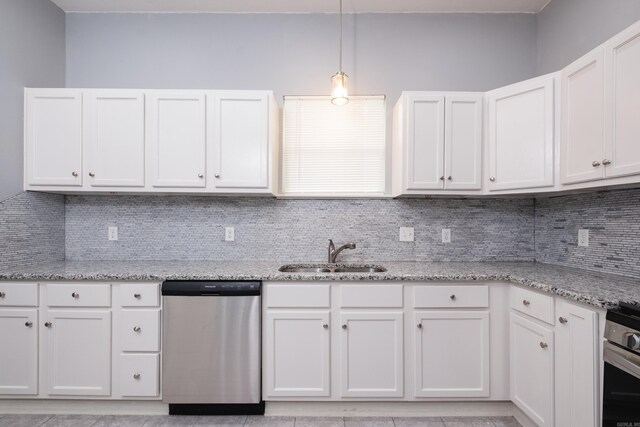 1407 Hanger St, Little Rock, AR 72202 - kitchen featuring appliances with stainless steel finishes, a sink, tasteful backsplash, and white cabinetry