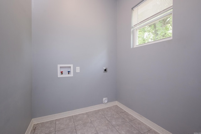 1407 Hanger St, Little Rock, AR 72202 - clothes washing area featuring hookup for an electric dryer, hookup for a washing machine, baseboards, and light tile patterned floors