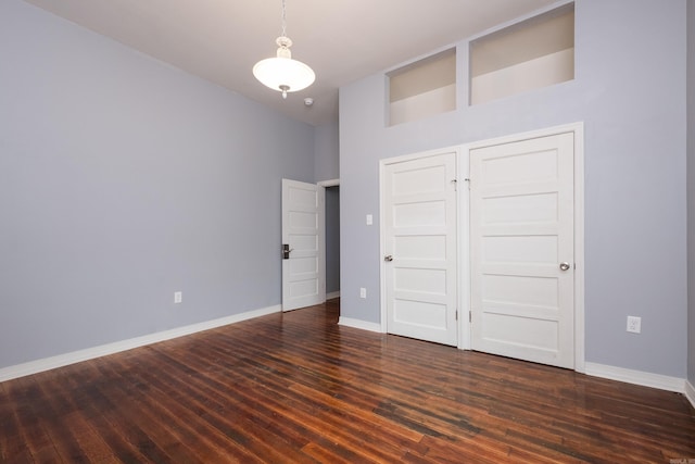 1407 Hanger St, Little Rock, AR 72202 - unfurnished bedroom featuring wood finished floors, baseboards, and a high ceiling