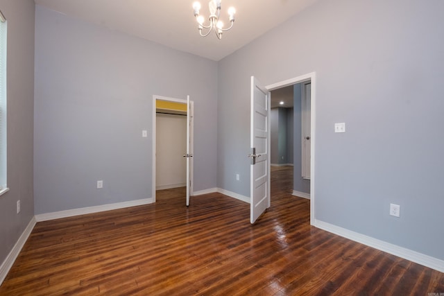 1407 Hanger St, Little Rock, AR 72202 - unfurnished bedroom with a chandelier, dark wood finished floors, baseboards, and a closet