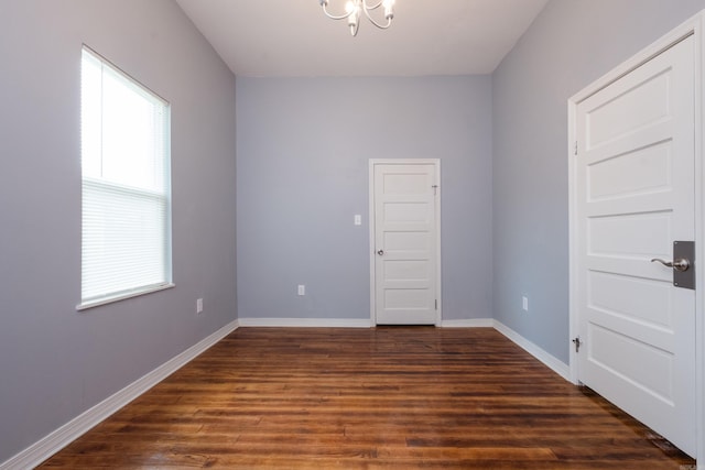 1407 Hanger St, Little Rock, AR 72202 - unfurnished room featuring dark wood finished floors, baseboards, and a chandelier