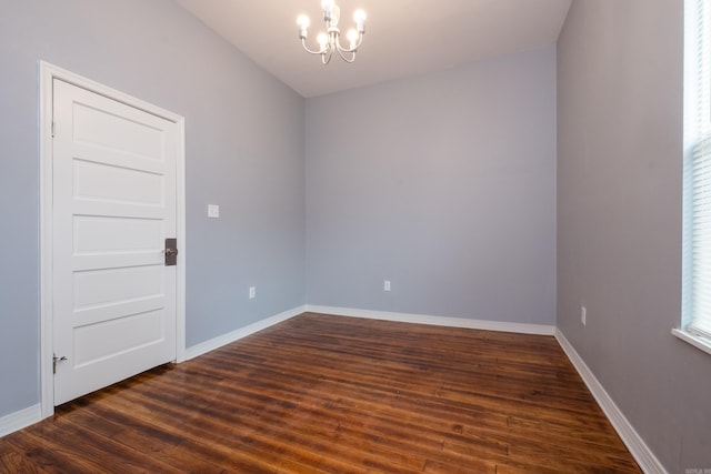 1407 Hanger St, Little Rock, AR 72202 - spare room featuring a chandelier, dark wood-type flooring, and baseboards