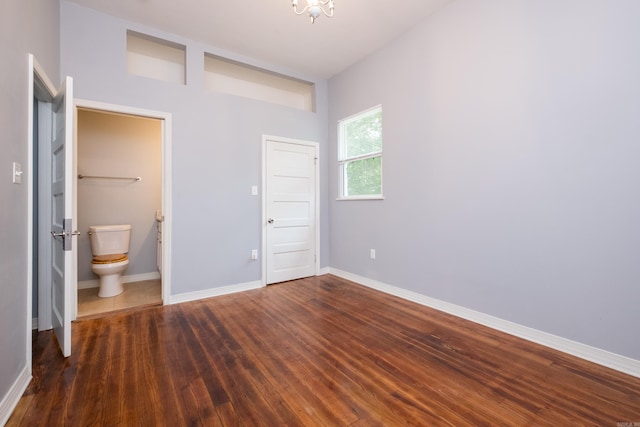 1407 Hanger St, Little Rock, AR 72202 - unfurnished bedroom featuring baseboards, wood finished floors, and ensuite bath