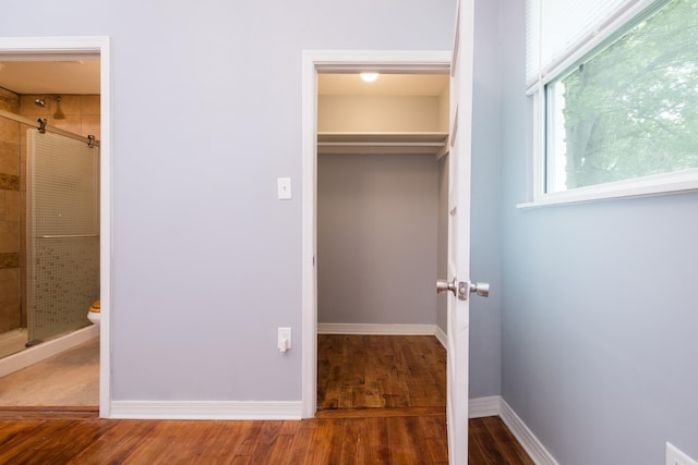 1407 Hanger St, Little Rock, AR 72202 - unfurnished bedroom featuring wood finished floors, ensuite bath, a closet, and baseboards