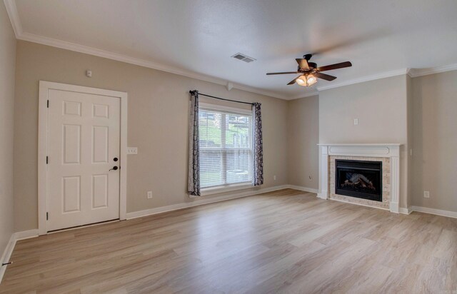 106 Venezia Ln, Maumelle, AR 72113 - unfurnished living room featuring ceiling fan, light wood-style flooring, a tiled fireplace, crown molding, and baseboards